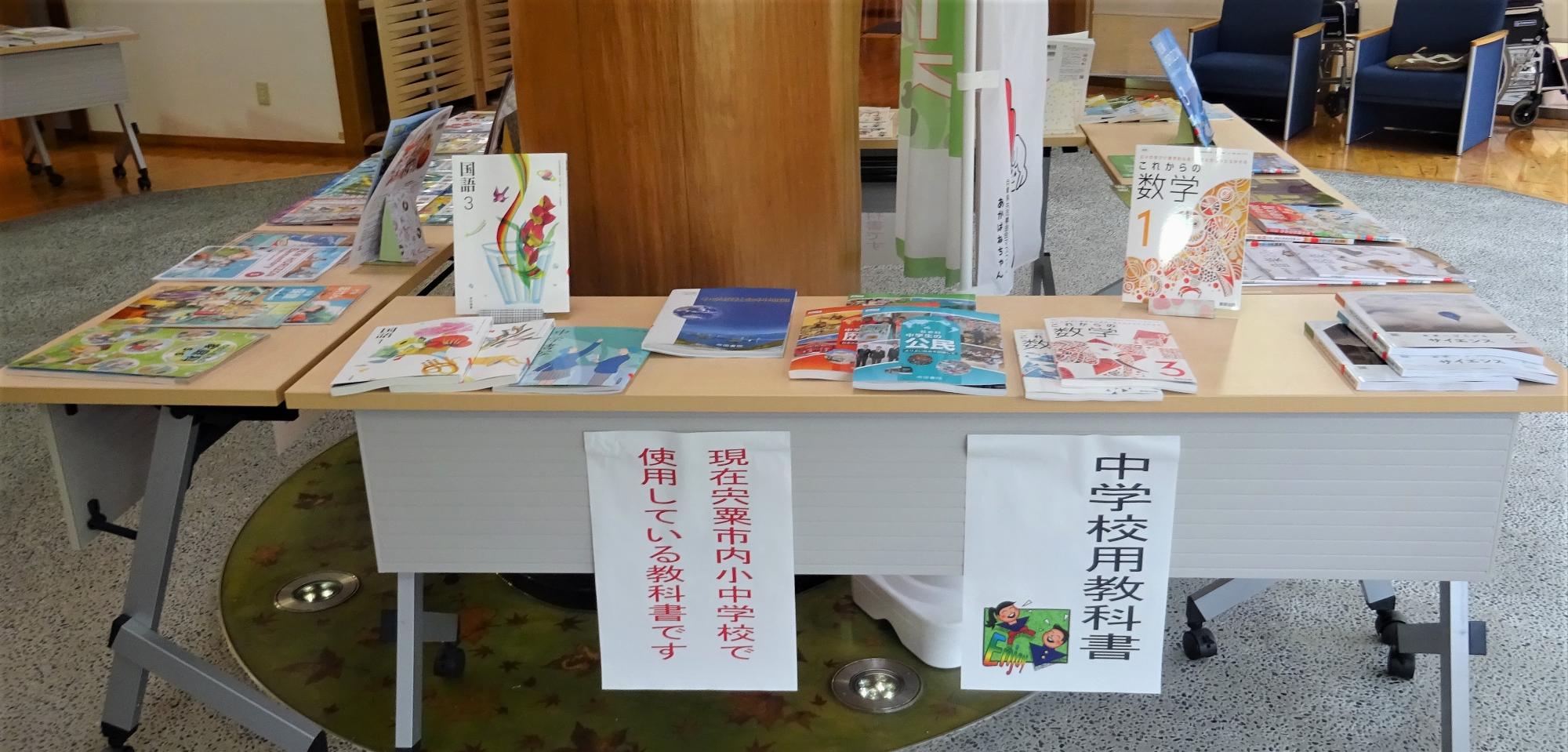 教科書展示会で市内の小中学校で使用されている教科書が手にとりやすいような状態で机に並べて置いてある写真