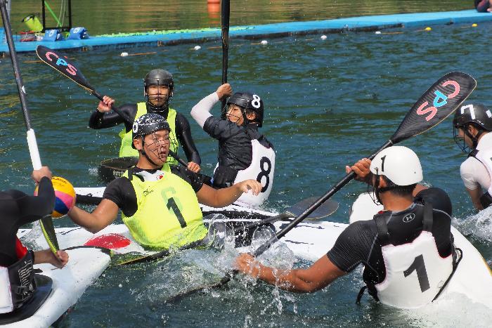 第2回音水湖カップカヌーポロ大会一般の部に出場している選手らがボールを追いかけ水しぶきを上げながら激しくぶつかり合っている写真