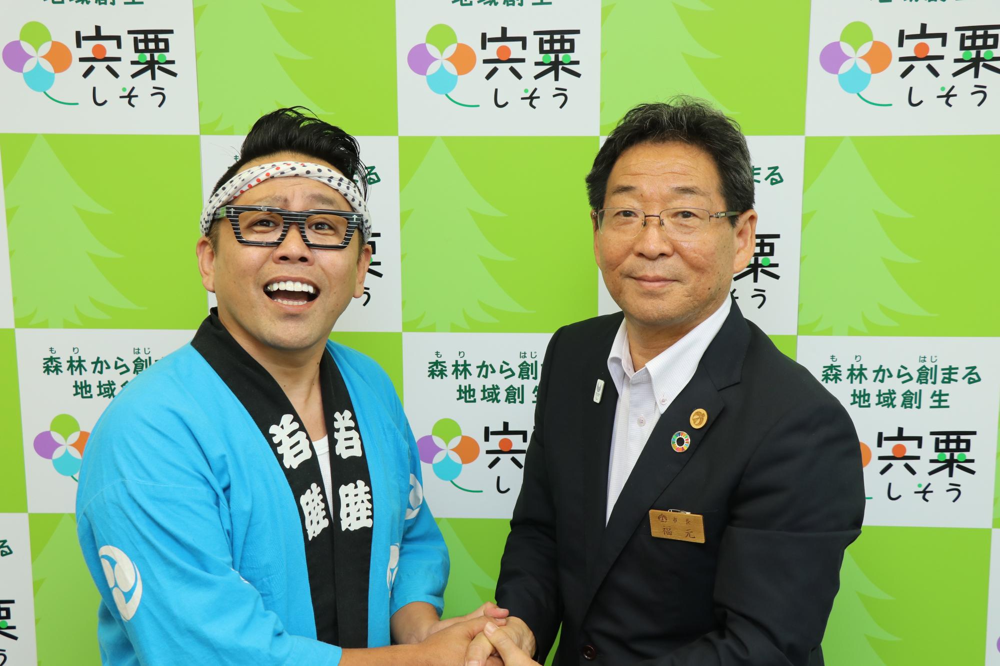 山田大地さんと田路市長が笑顔で握手している写真
