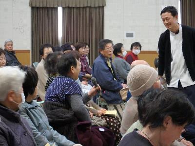 理学療法士の小林憲人さんが講演で高齢者に話かけている写真