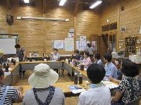 環境に関わる学習会で机を囲んで話を聞いている参加者らの写真