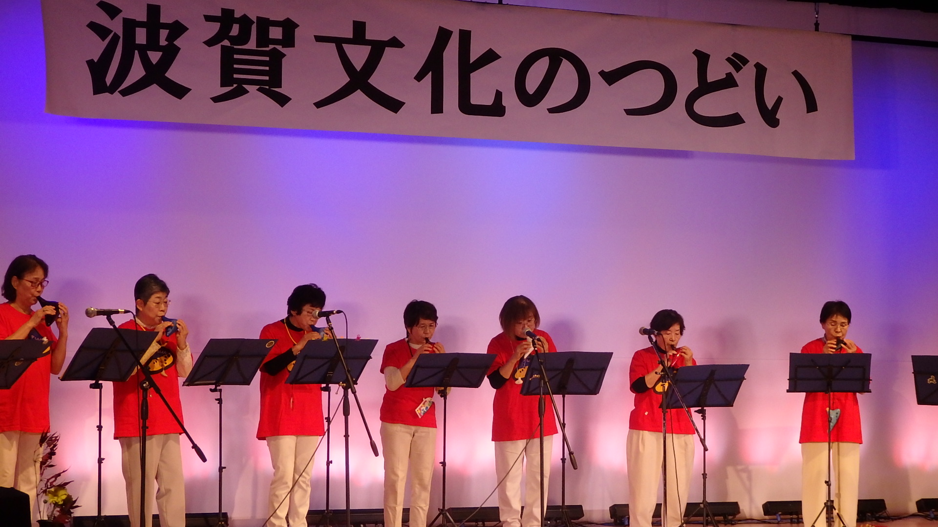 オカリナクラブのメンバーが揃いの服装でオカリナ演奏を披露している写真