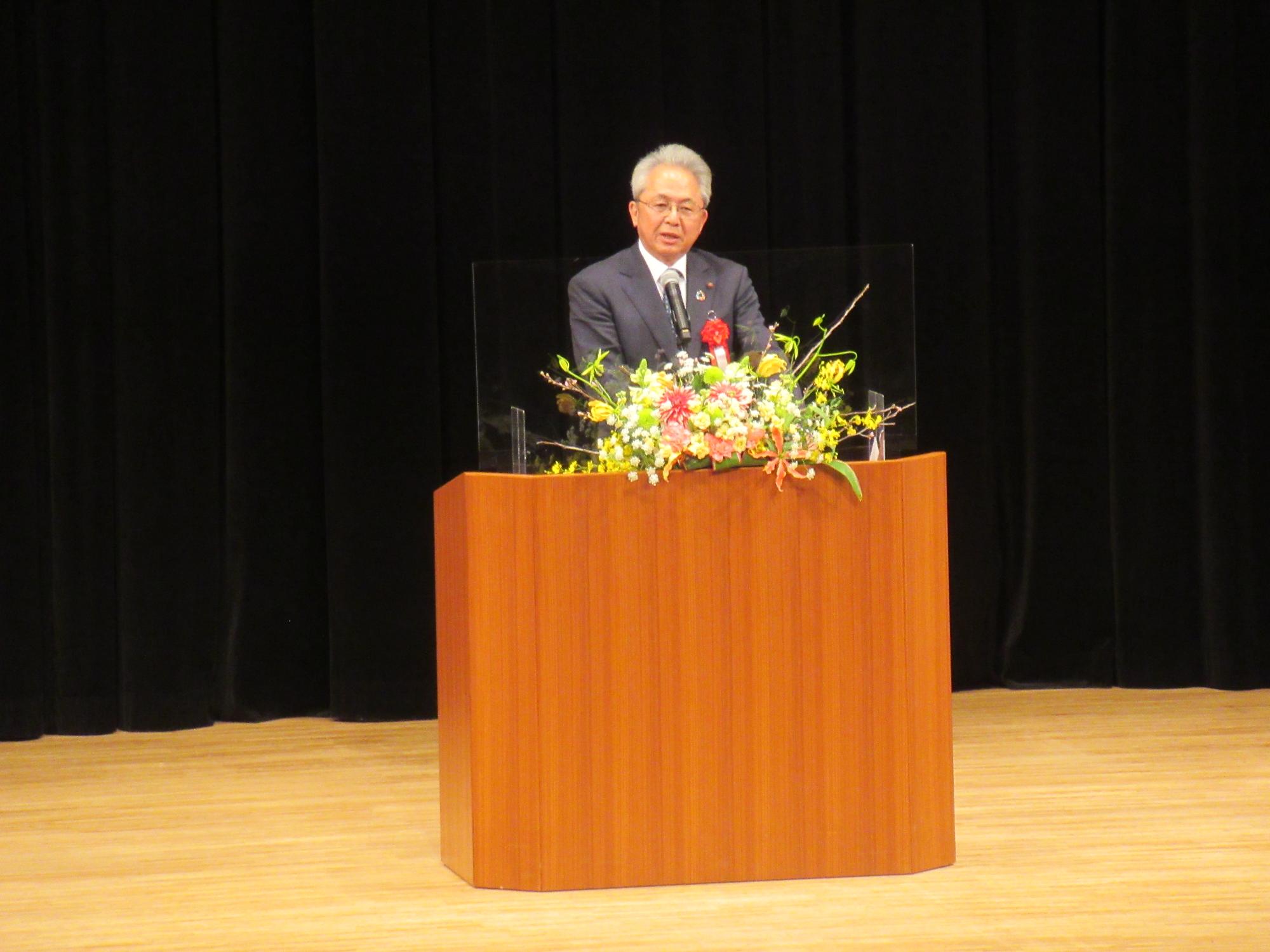 閉講式で祝辞を述べる飯田議会議長の写真