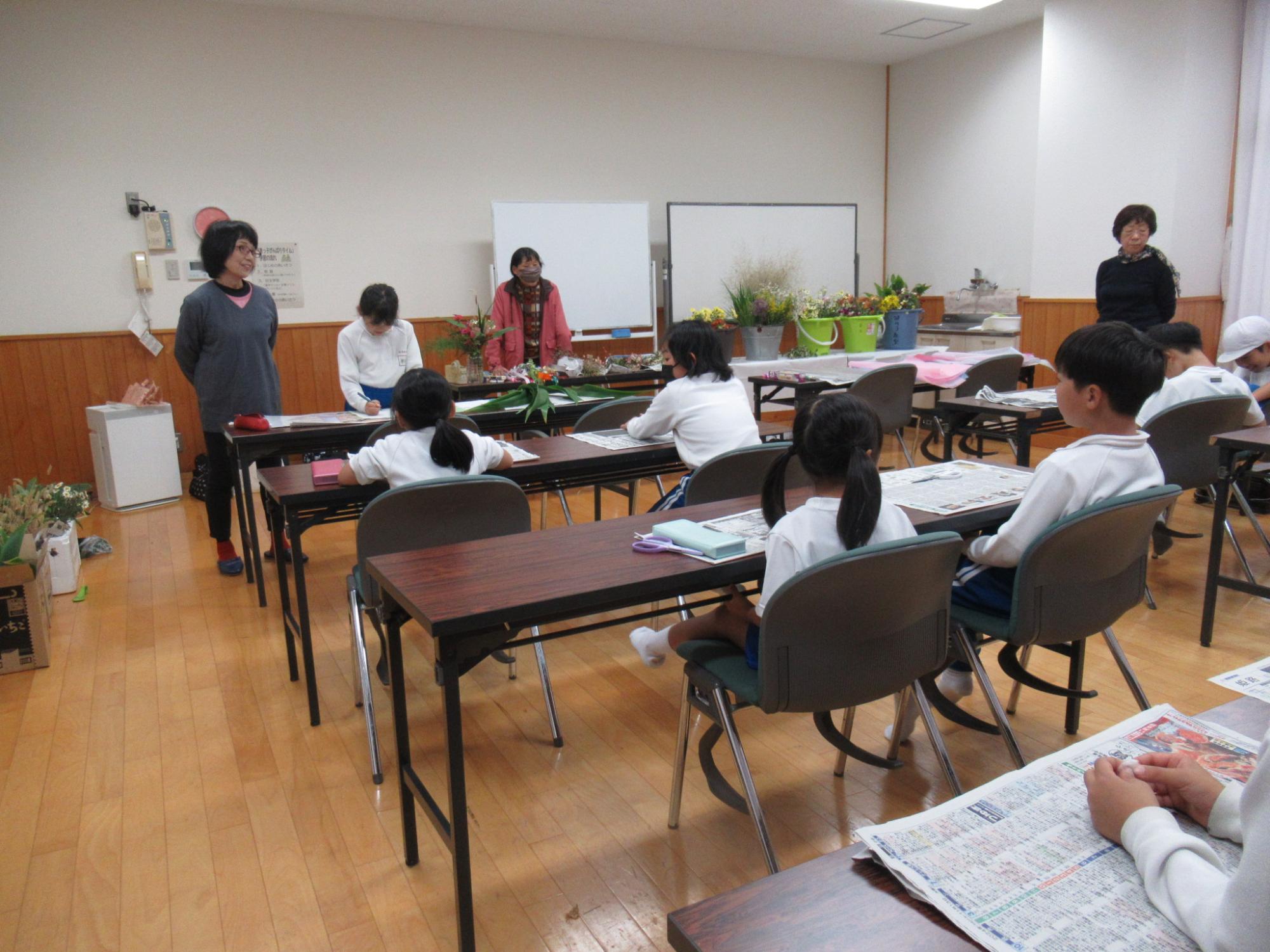 参加者が席に着いている中、サポーターが出席状況を確認している写真