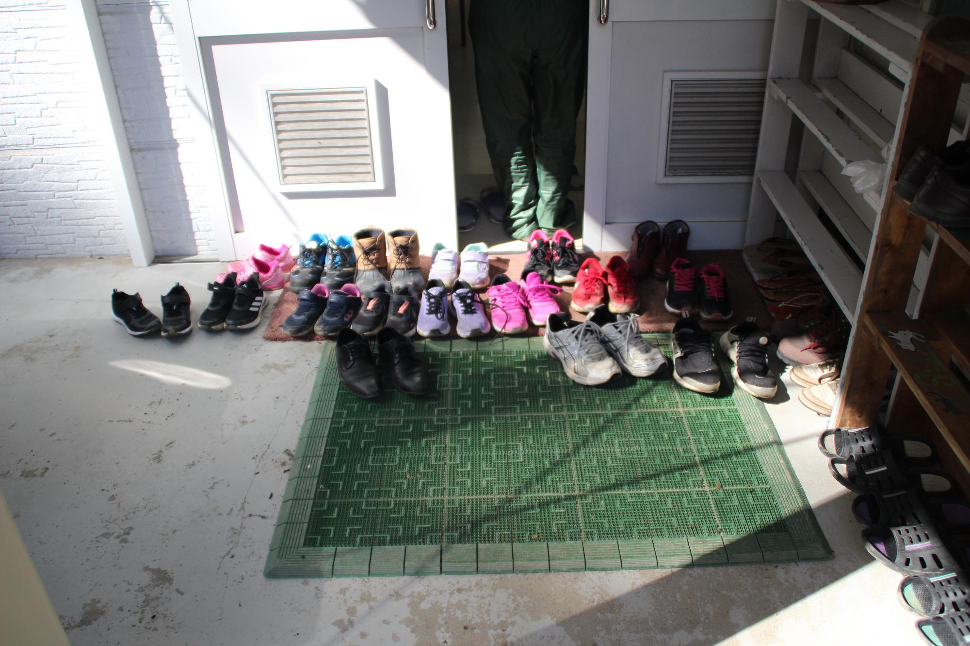 作業をする調理室へ入室した児童らの靴ががきちんと並べられている写真